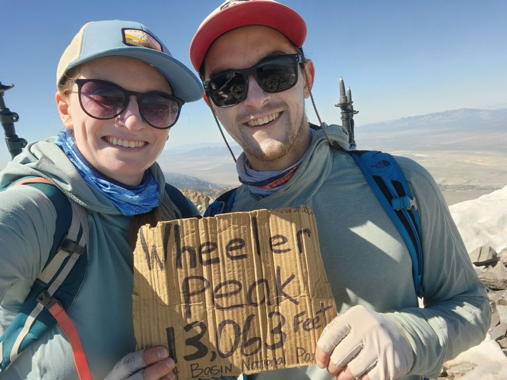 Jon-David and Molly holding up the Wheeler Peak summit sign.