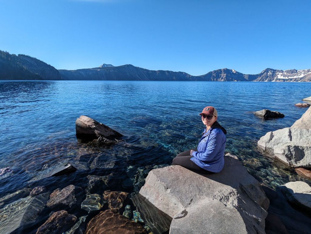 Molly dipping her feet in Crater Lake